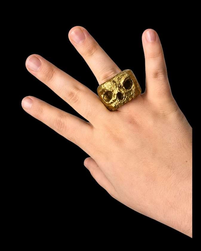 The brass skull ring, worn